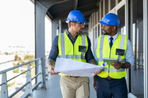 Architects discussing plan at construction site